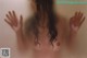 A naked woman with her hands outstretched in the air.